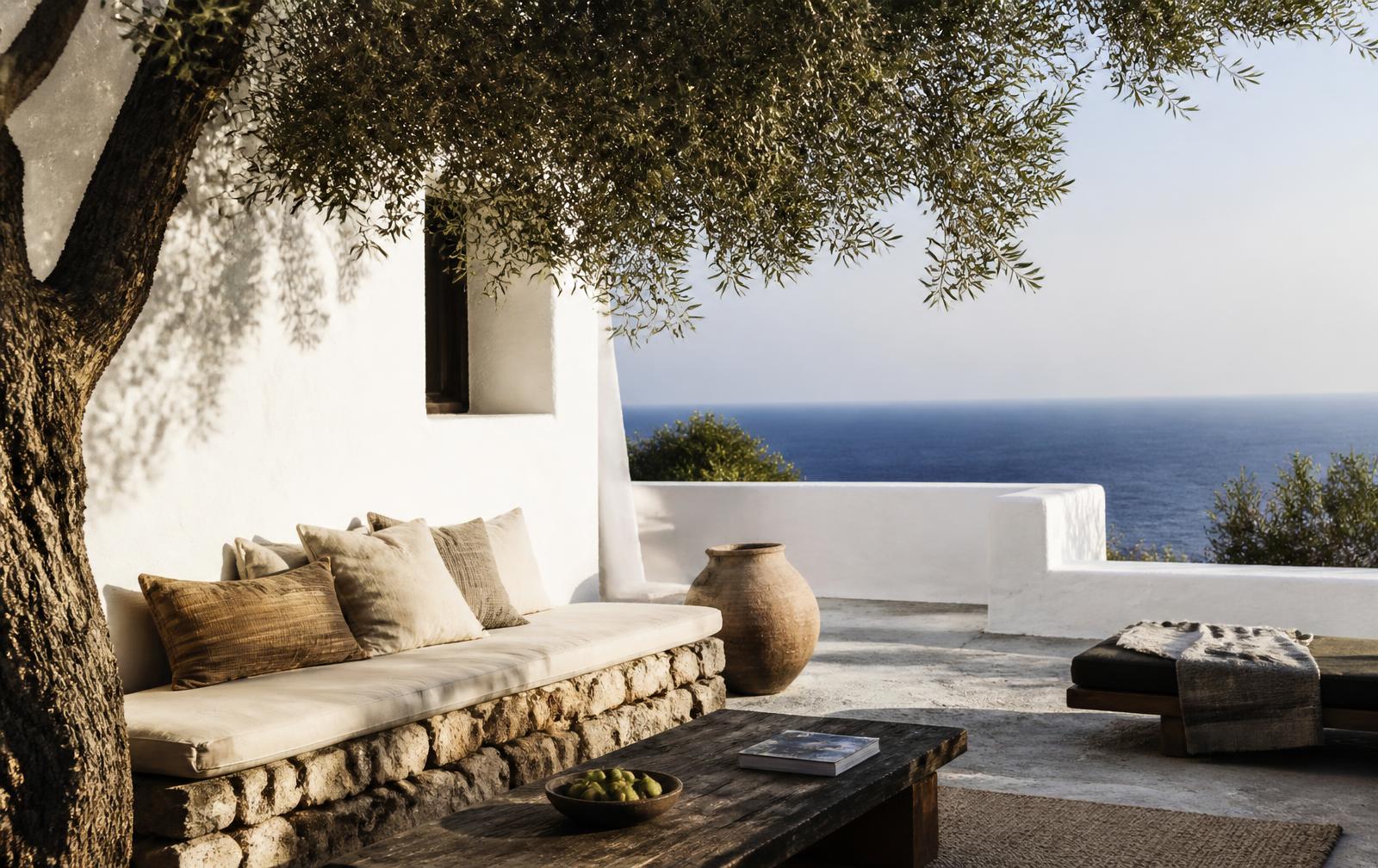 Whitewashed Mediterranean terrace with olive tree and sea horizon